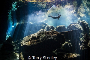   Freediver enjoys tranquility crystal clear water. Subal underwater housing Zen DP230 Canon 1Dx EF815mm 15mm f9 180 ISO500 available light water EF8-15mm EF8 1/80, 180, 80,  